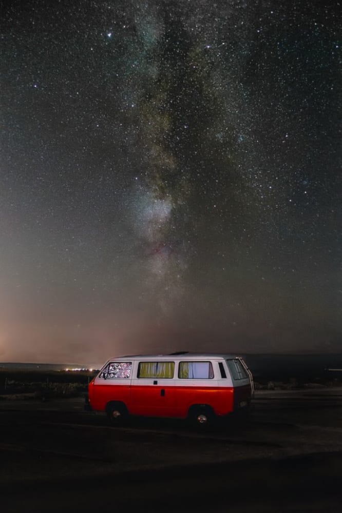 van parked with milkway in the sky