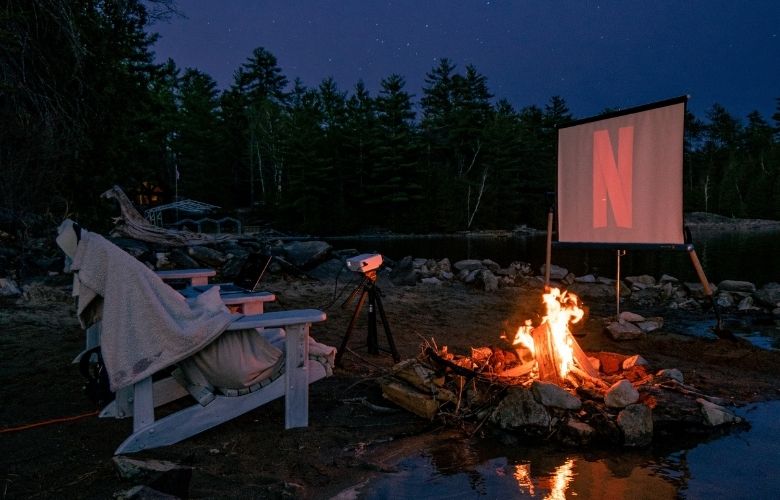 Netflix viewing setup for a couple next to a bonfire